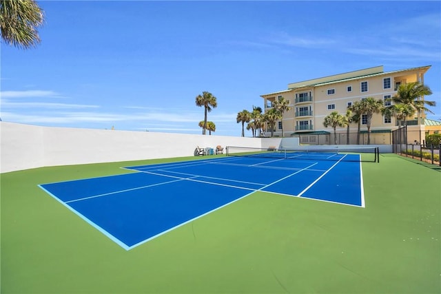 view of tennis court with fence and community basketball court