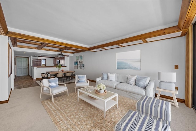 living room with baseboards, beam ceiling, a ceiling fan, and light colored carpet
