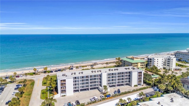 drone / aerial view featuring a view of the beach and a water view