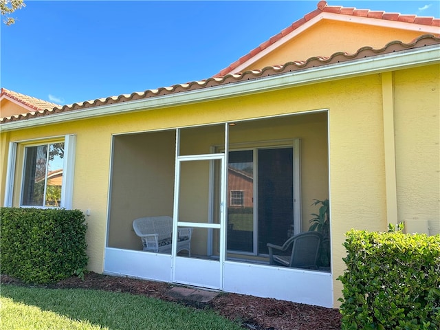 view of side of property with a sunroom