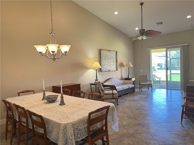 dining area with tile patterned floors, ceiling fan with notable chandelier, and high vaulted ceiling