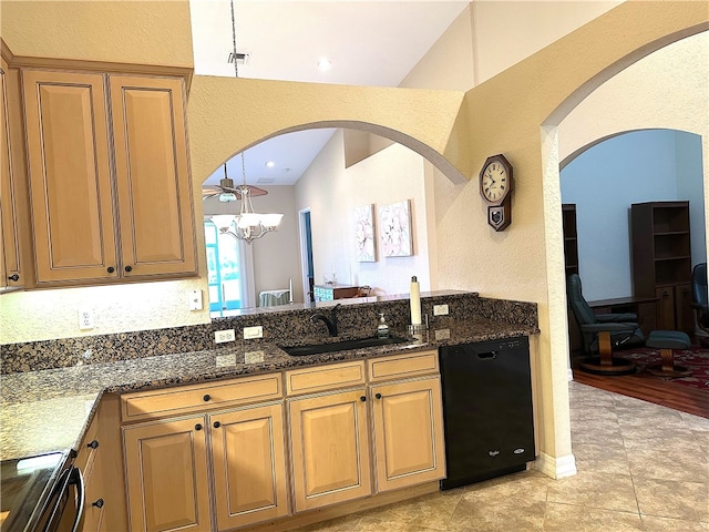 kitchen featuring sink, vaulted ceiling, dark stone countertops, black dishwasher, and range