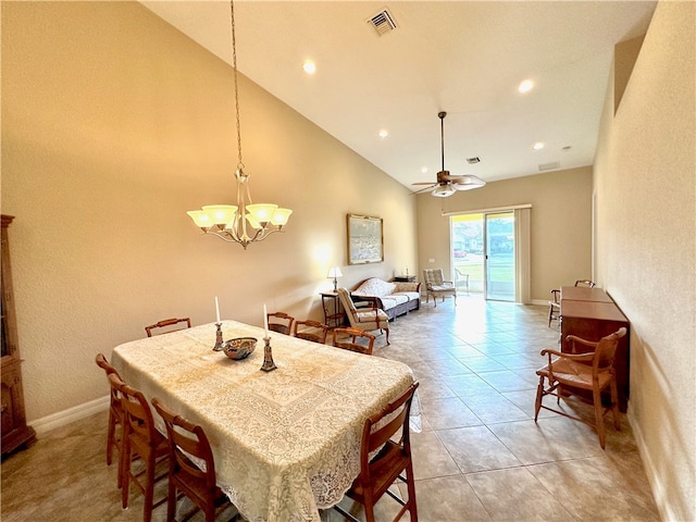 dining area with light tile patterned floors, ceiling fan with notable chandelier, and high vaulted ceiling