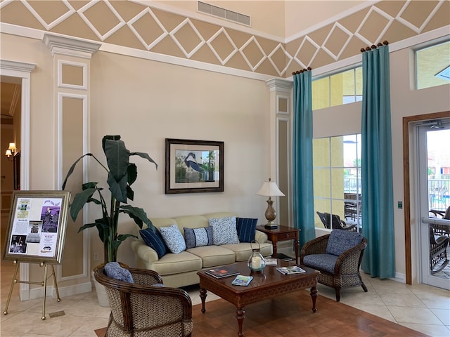 tiled living room with ornate columns and a towering ceiling