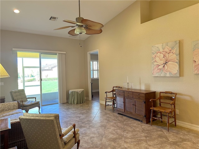 sitting room featuring ceiling fan, light tile patterned flooring, and lofted ceiling