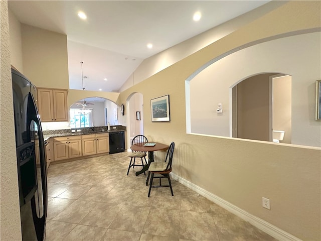 kitchen featuring pendant lighting, light brown cabinets, lofted ceiling, black appliances, and ceiling fan