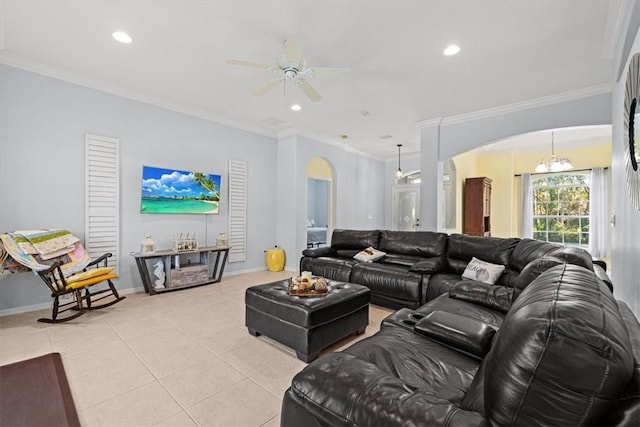 living room featuring ceiling fan with notable chandelier, ornamental molding, and light tile patterned floors