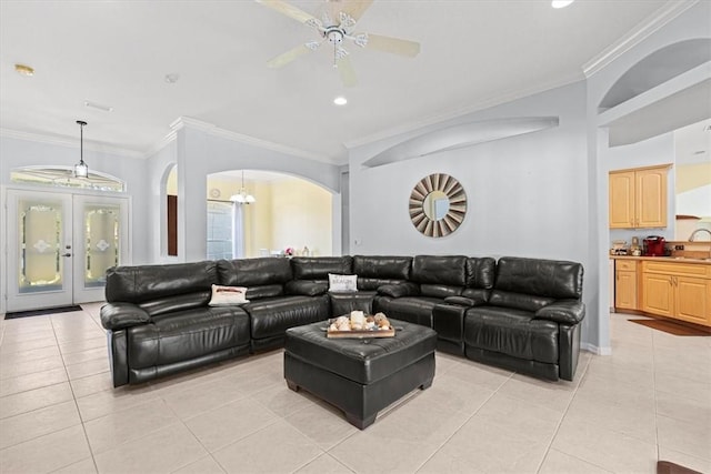 tiled living room with ceiling fan, ornamental molding, and sink