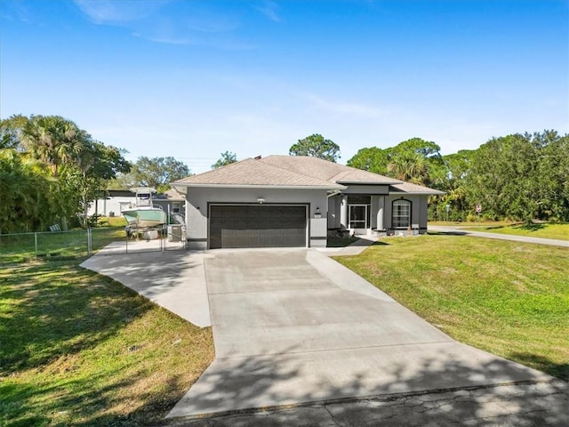 ranch-style house featuring a front lawn and a garage