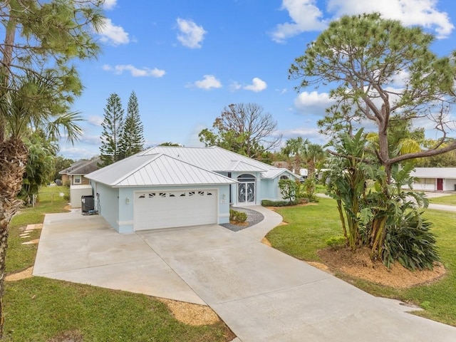 ranch-style home with a front yard, central AC, and a garage