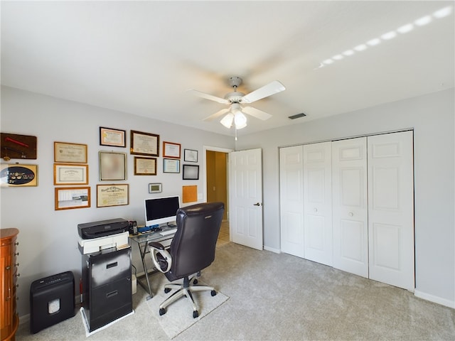 office space with light carpet and ceiling fan