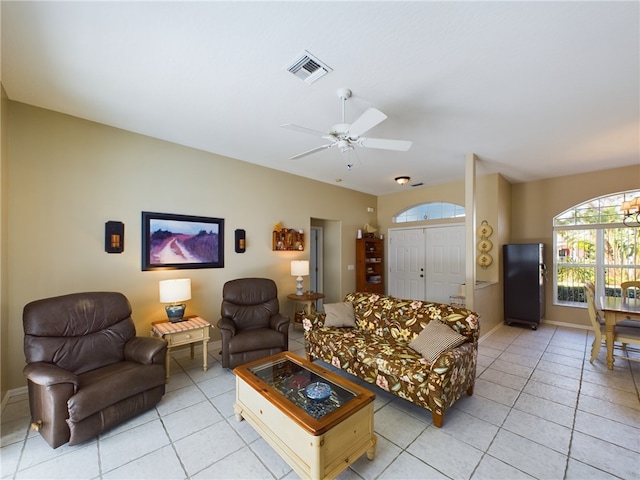 living room with light tile patterned floors and ceiling fan