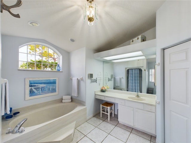 bathroom with tile patterned flooring, vanity, lofted ceiling, and a washtub