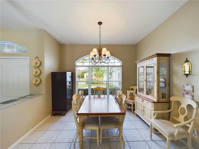 tiled dining space with an inviting chandelier