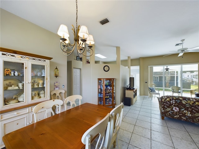 dining space with light tile patterned floors and ceiling fan with notable chandelier