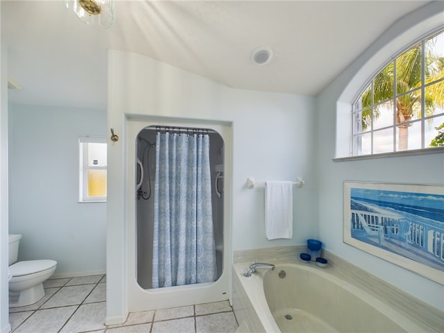 bathroom with toilet, a tub to relax in, and tile patterned floors