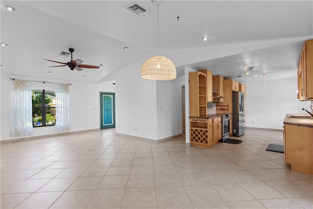 interior space with appliances with stainless steel finishes, pendant lighting, sink, lofted ceiling, and ceiling fan