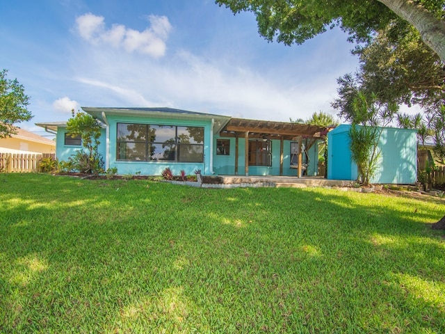 rear view of property with a pergola and a yard