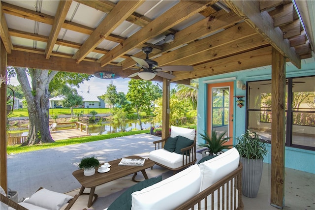 view of patio / terrace featuring a water view and ceiling fan