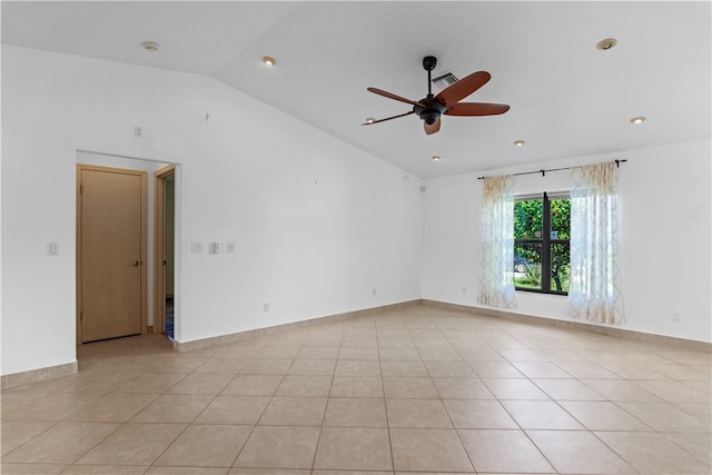 tiled empty room featuring lofted ceiling and ceiling fan