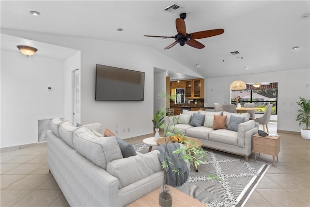 tiled living room with lofted ceiling and ceiling fan