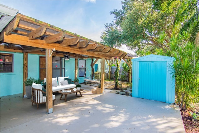 view of patio / terrace featuring a storage unit, ceiling fan, a pergola, and an outdoor hangout area