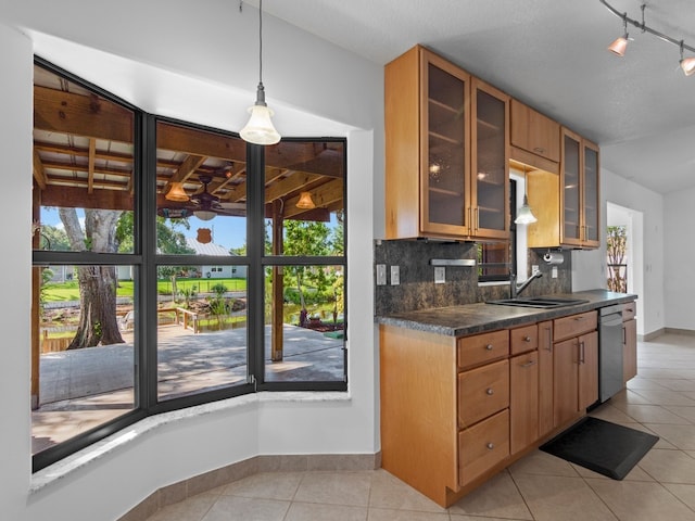 kitchen with light tile patterned flooring, decorative light fixtures, decorative backsplash, sink, and dishwasher