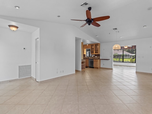 unfurnished living room featuring lofted ceiling, light tile patterned flooring, and ceiling fan