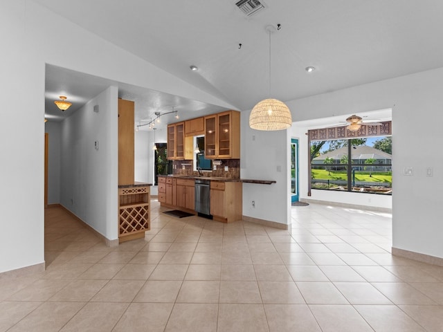 kitchen featuring ceiling fan, light tile patterned floors, stainless steel dishwasher, hanging light fixtures, and lofted ceiling