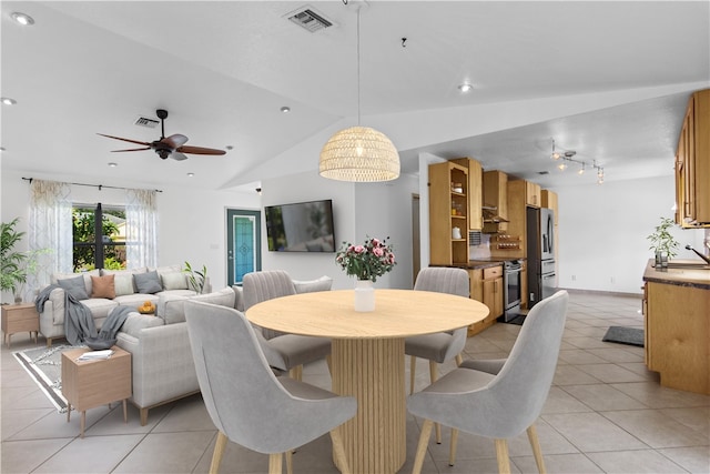 dining area featuring lofted ceiling, light tile patterned floors, ceiling fan, and sink