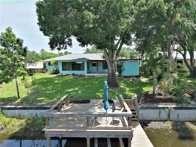 exterior space with a yard and a deck with water view