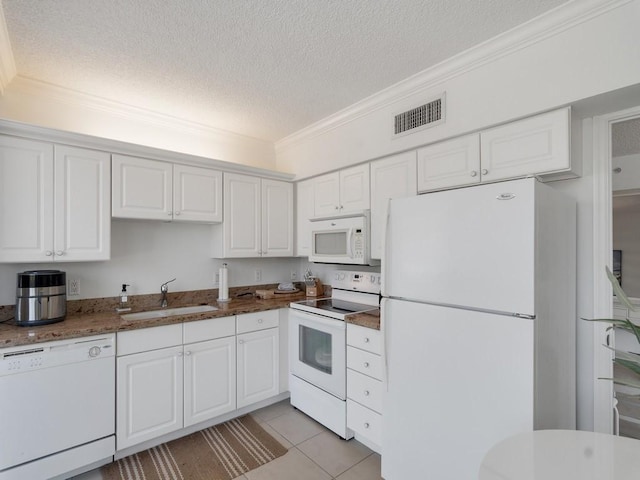 3554 Ocean Dr Unit 202S, Vero Beach, FL 32963 - kitchen featuring white appliances, a textured ceiling, a sink, crown molding, and white cabinets