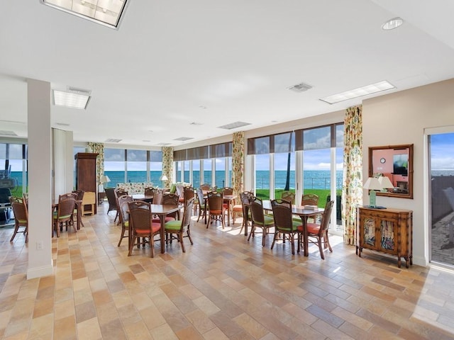 3554 Ocean Dr Unit 202S, Vero Beach, FL 32963 - dining area featuring a water view, a wall of windows, and healthy amount of natural light