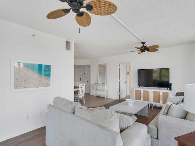 3554 Ocean Dr Unit 202S, Vero Beach, FL 32963 - living area with ceiling fan, dark wood finished floors, a textured ceiling, and baseboards