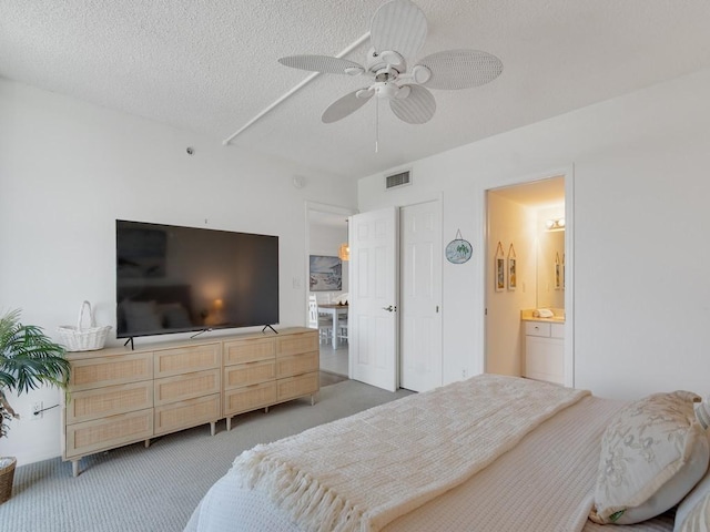 3554 Ocean Dr Unit 202S, Vero Beach, FL 32963 - bedroom featuring light carpet, a textured ceiling, a ceiling fan, and connected bathroom