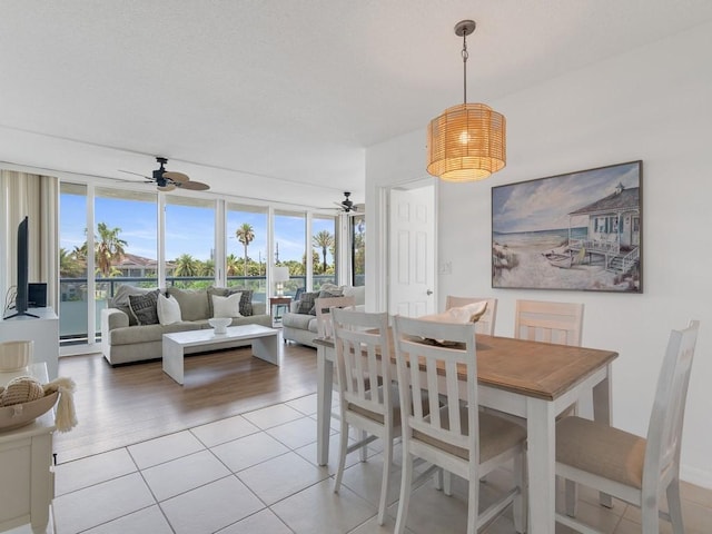 3554 Ocean Dr Unit 202S, Vero Beach, FL 32963 - dining room with ceiling fan, plenty of natural light, light tile patterned flooring, and floor to ceiling windows