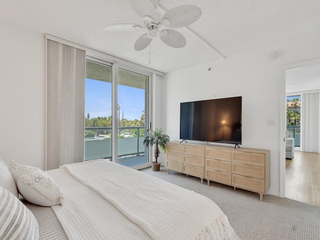 3554 Ocean Dr Unit 202S, Vero Beach, FL 32963 - carpeted bedroom with a wall of windows, a textured ceiling, ceiling fan, and access to exterior