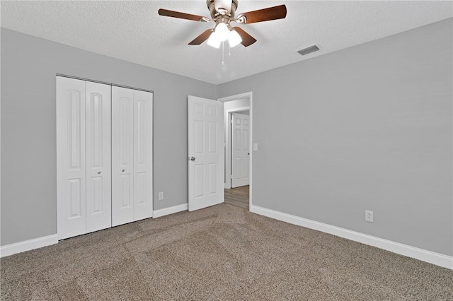 705 10th Ave SW, Vero Beach, FL 32962 - unfurnished bedroom with carpet, a textured ceiling, a closet, and ceiling fan