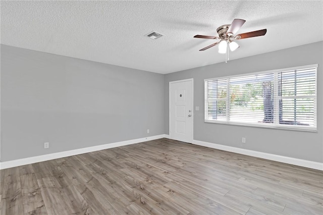 705 10th Ave SW, Vero Beach, FL 32962 - unfurnished room featuring a ceiling fan, a textured ceiling, and wood finished floors