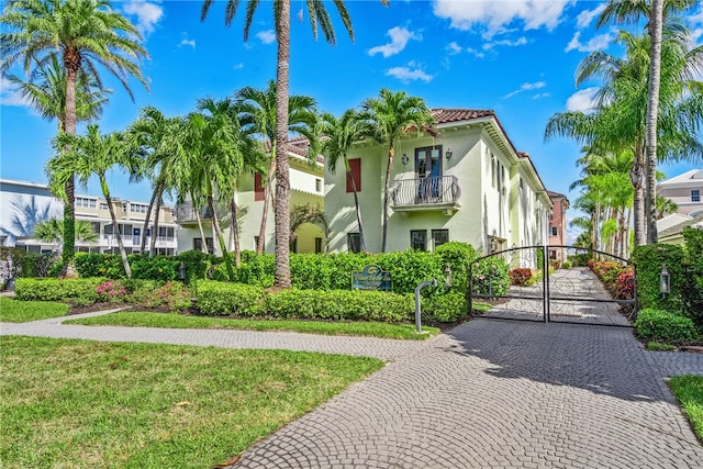 exterior space featuring a balcony and a front yard