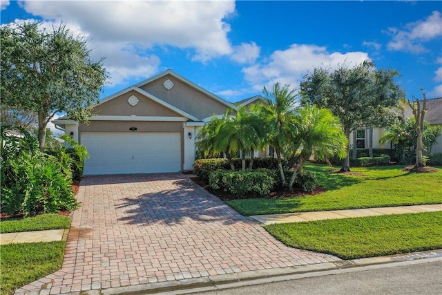 view of front of house with a garage and a front lawn