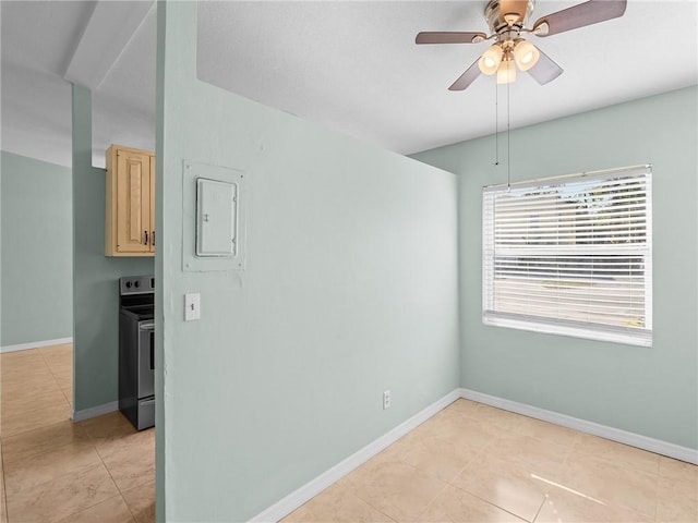 tiled empty room with electric panel and ceiling fan