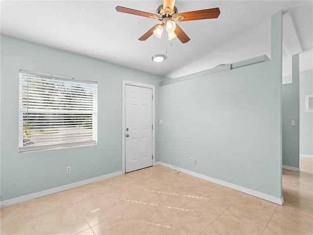 tiled spare room featuring ceiling fan