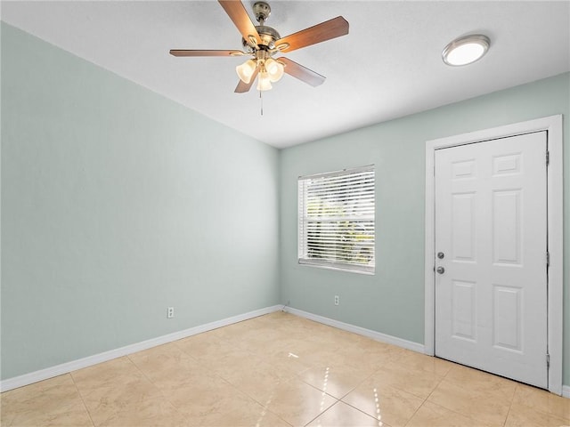 unfurnished room featuring ceiling fan and light tile patterned floors