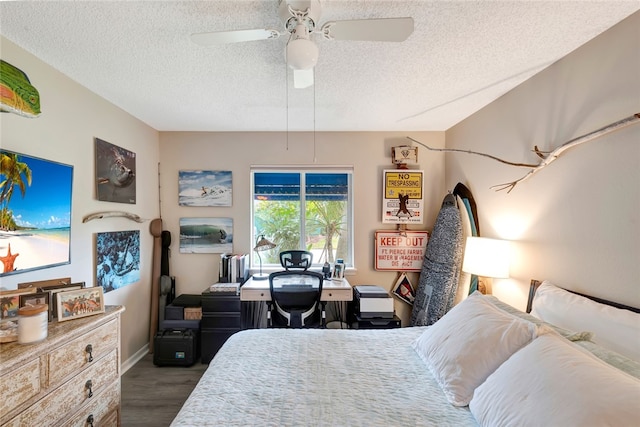 bedroom featuring dark hardwood / wood-style flooring, a textured ceiling, and ceiling fan