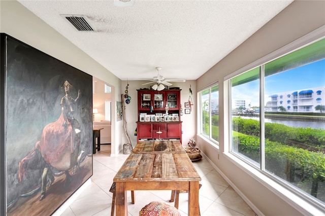 sunroom featuring ceiling fan