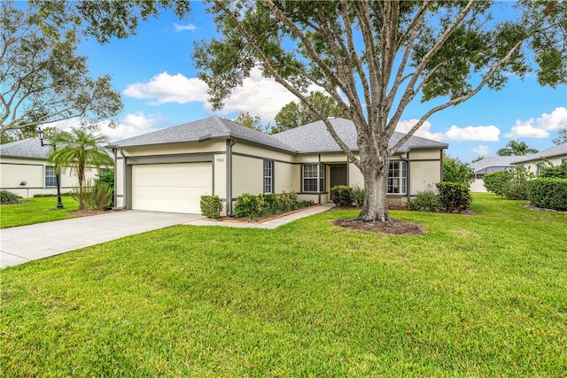 single story home featuring a front lawn and a garage