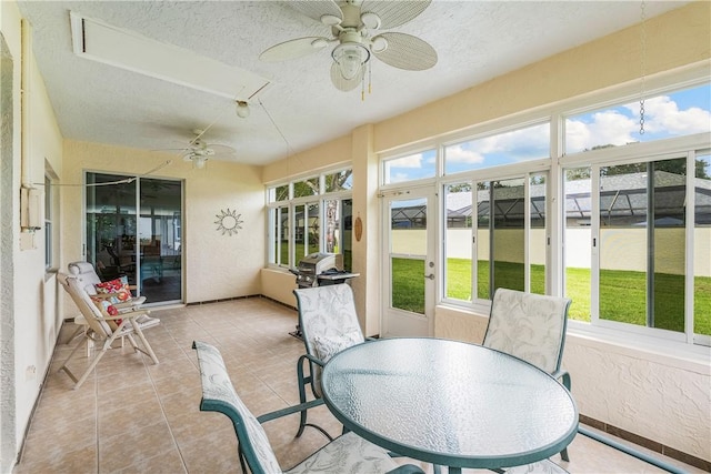 sunroom / solarium featuring ceiling fan