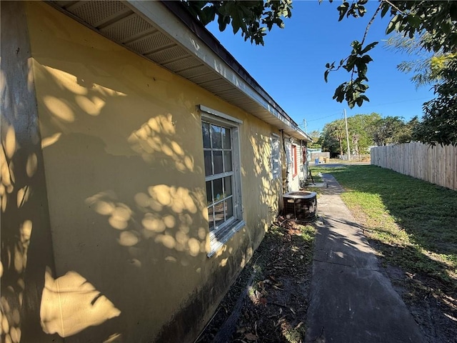 view of side of home with central air condition unit