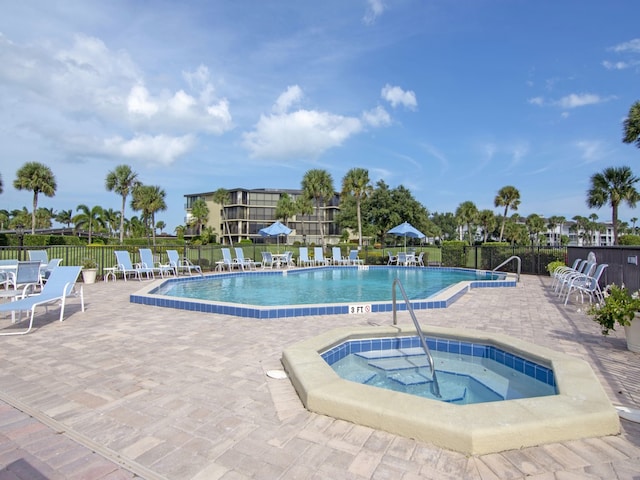 view of swimming pool with a patio and a community hot tub